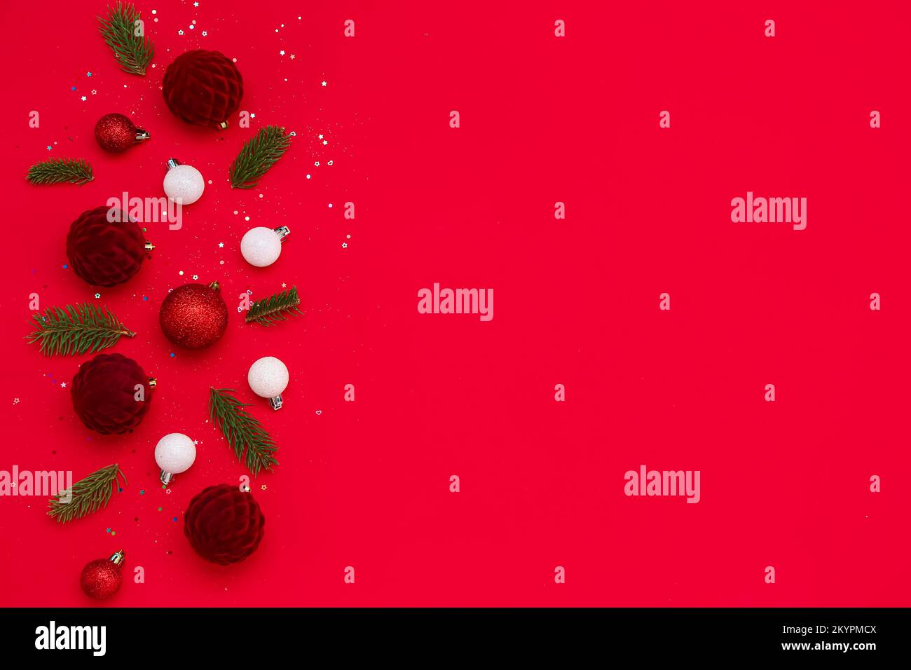 Christmas balls with fir branches and sequins on red background Stock ...