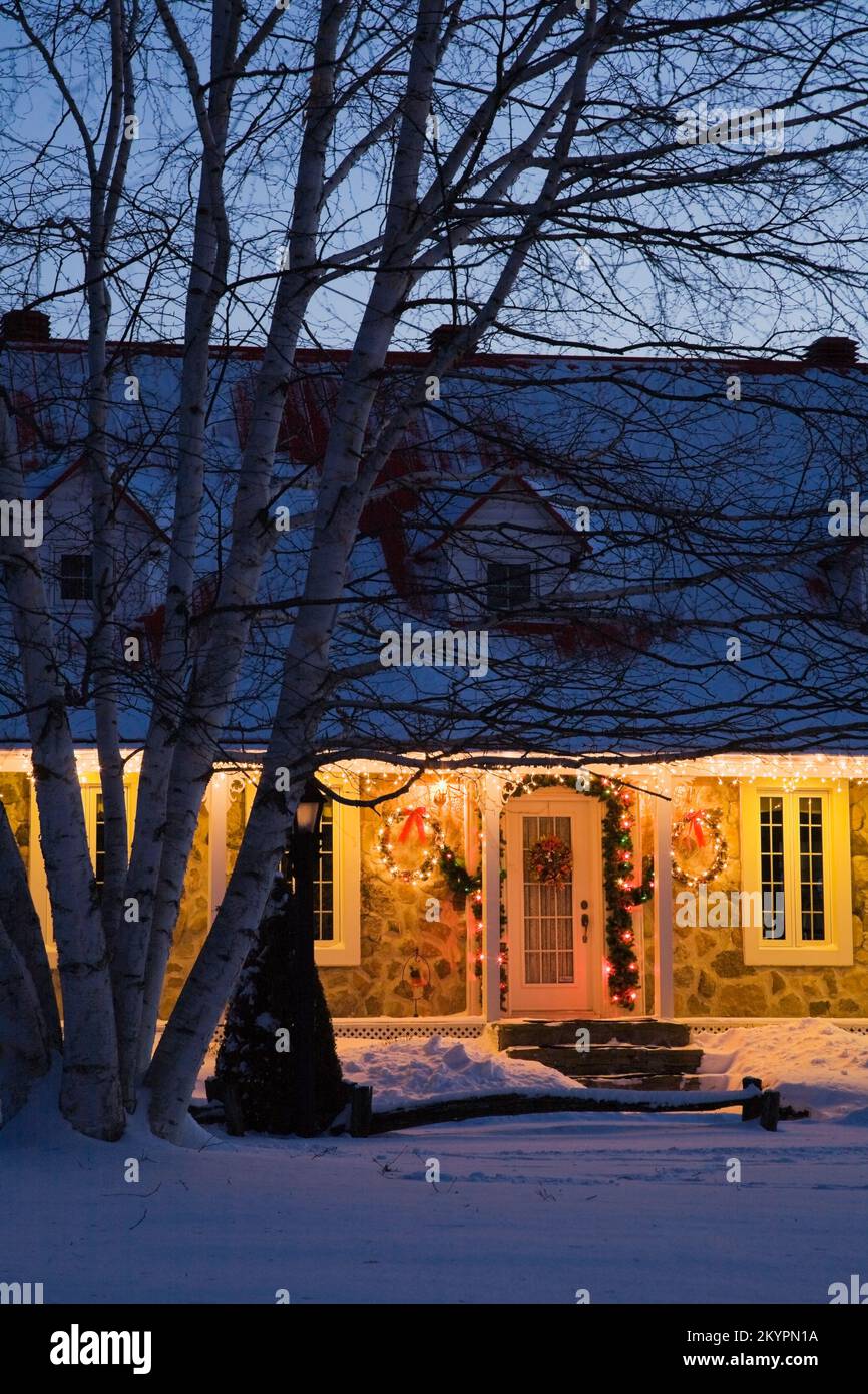 Illuminated two storied fieldstone Canadiana style home decorated with