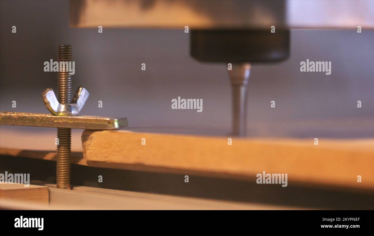 Closeup of wood cutting machine controlled by computer while he is