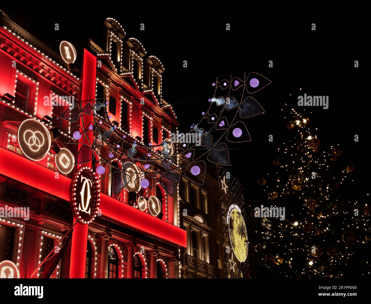 Cartier Jewellery Store Christmas Display with Ribbon effect on New Bond Street with a Christmas Tree in the foreground, London. Stock Photo