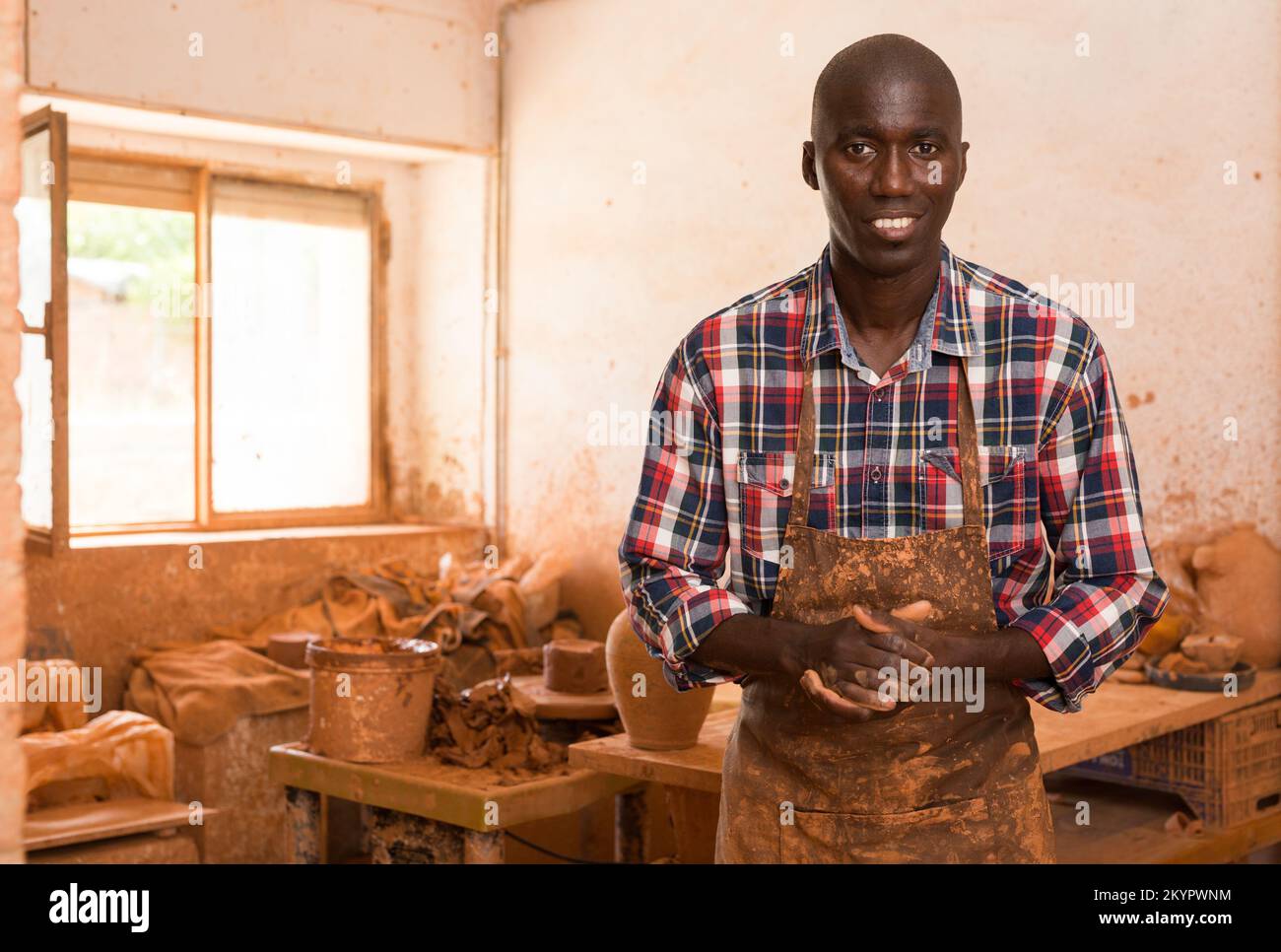 Craftsman in pottery workshop Stock Photo - Alamy