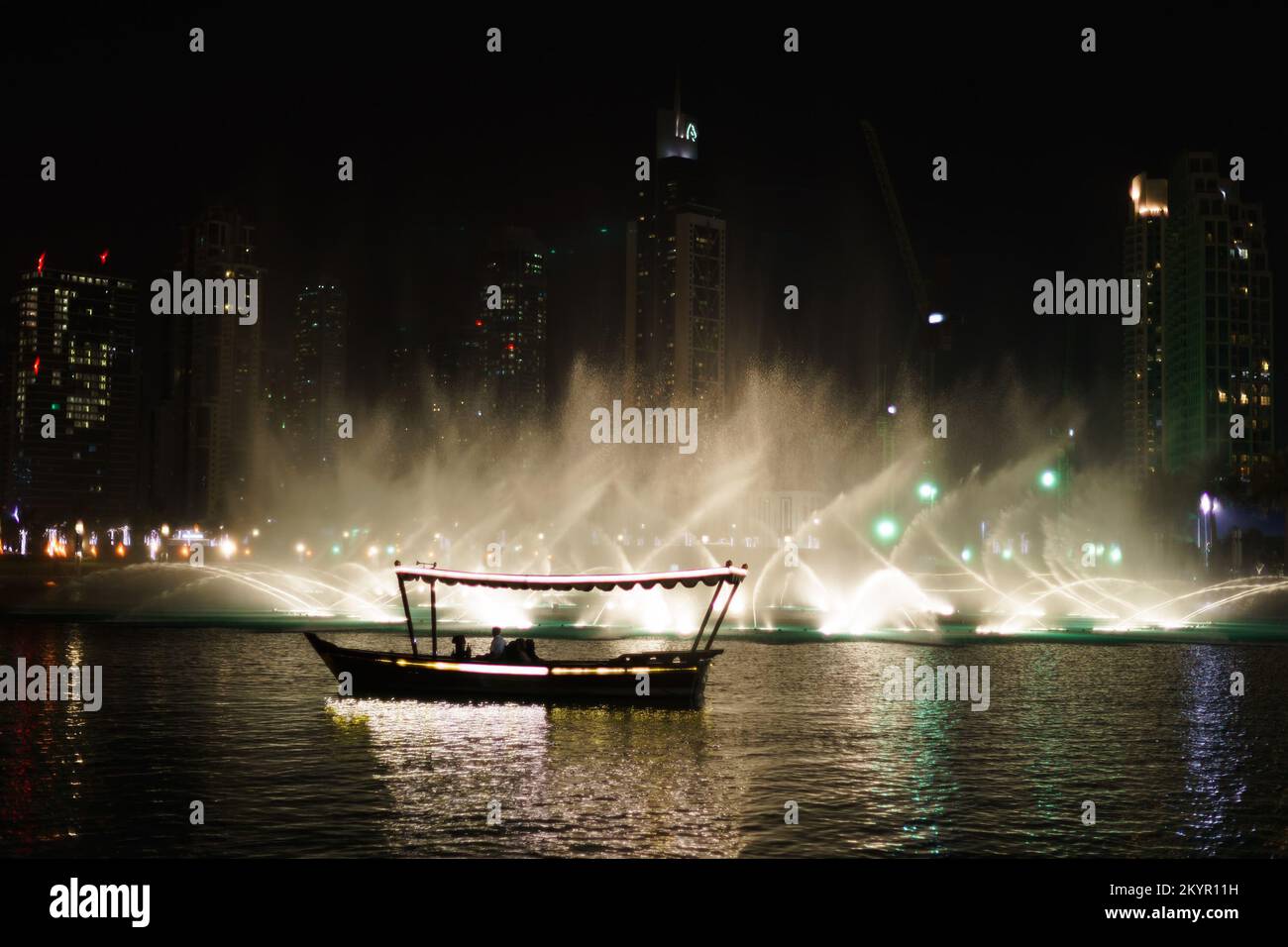 DUBAI, UAE - OCTOBER 15, 2014: The Dubai Fountain at night. The Dubai Fountain is the world's largest choreographed fountain system set on the 30-acre Stock Photo