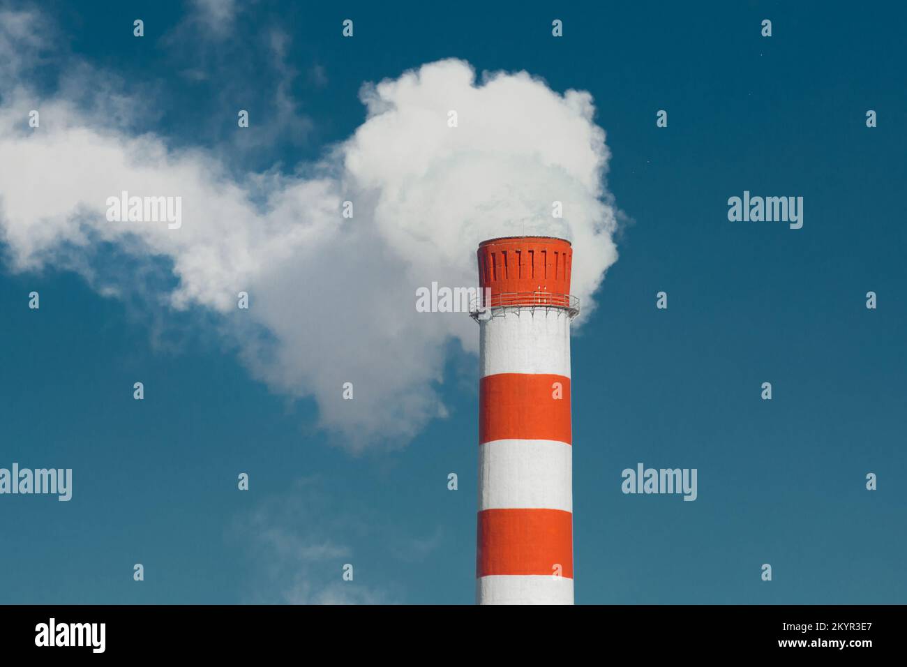 Pollution of the environment, ecology and air. Withdrawal of combustion products of soot, smoke and gases from the pipe of an industrial plant into th Stock Photo