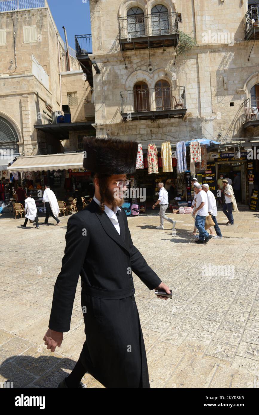 An Orthodox Jewish man walking through the Omar Ibn ElKhattab Sq. near