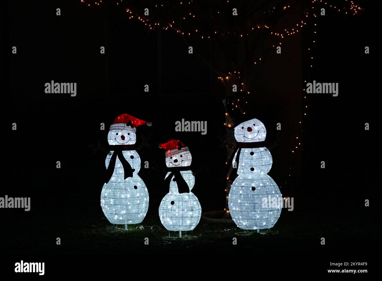 Lake Elsinore, CA, USA - Dec 1, 2022: Illuminated Christman snowfamily yard decoration Stock Photo