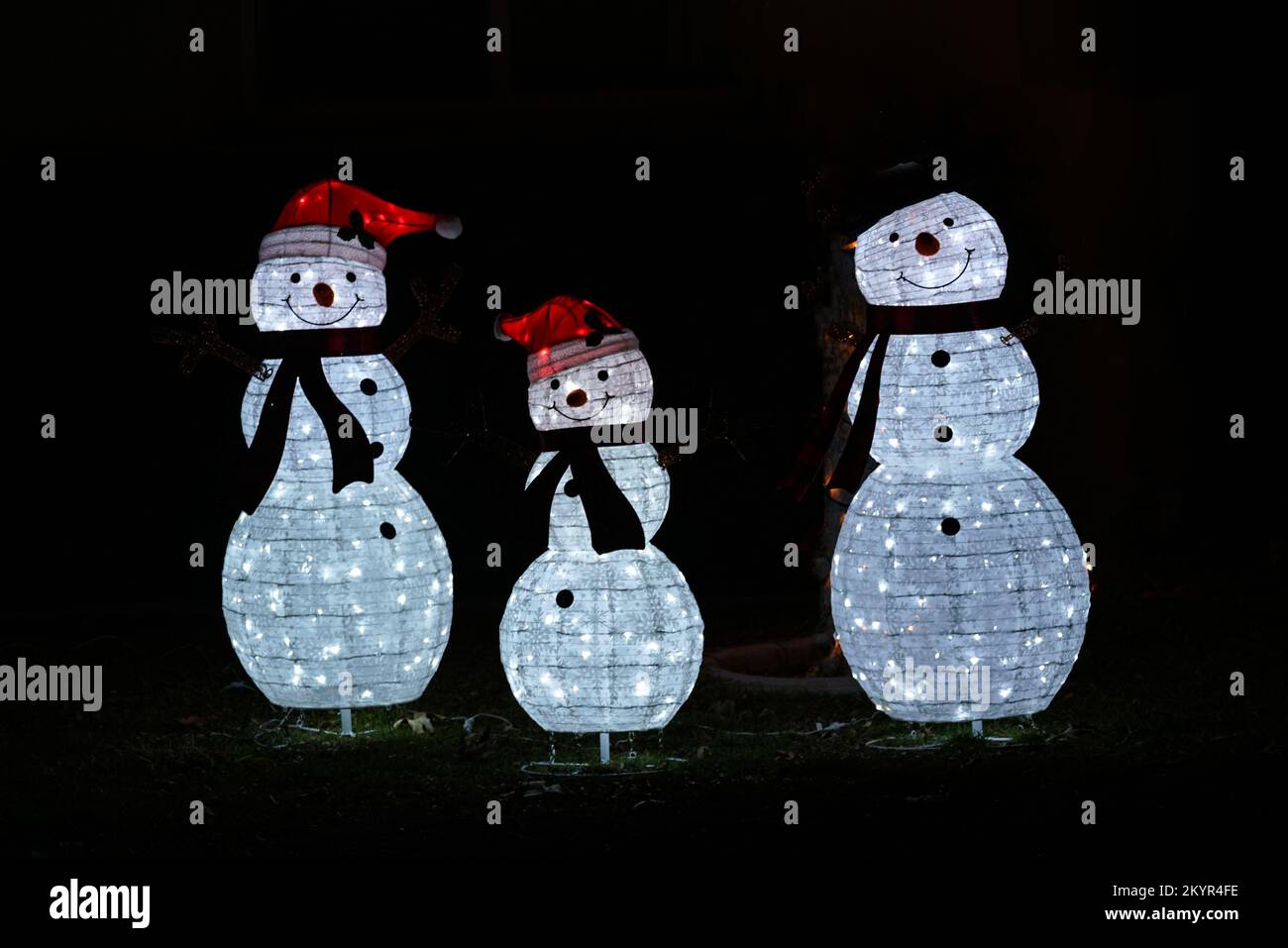 Lake Elsinore, CA, USA - Dec 1, 2022: Illuminated Christman snowfamily yard decorations Stock Photo