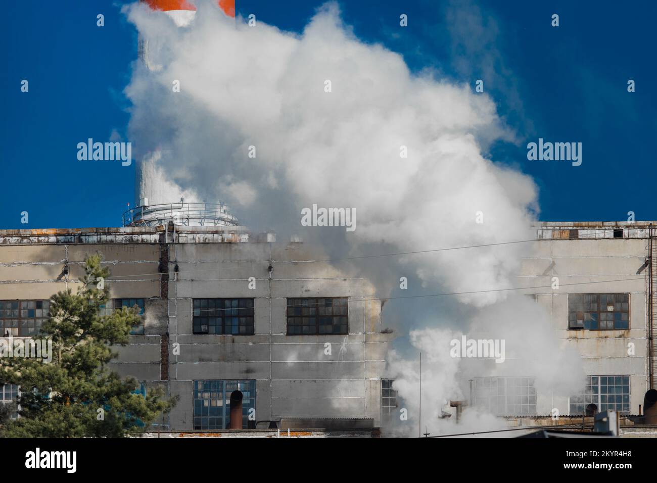 Emission of caustic toxic steam smoke at the plant industry and