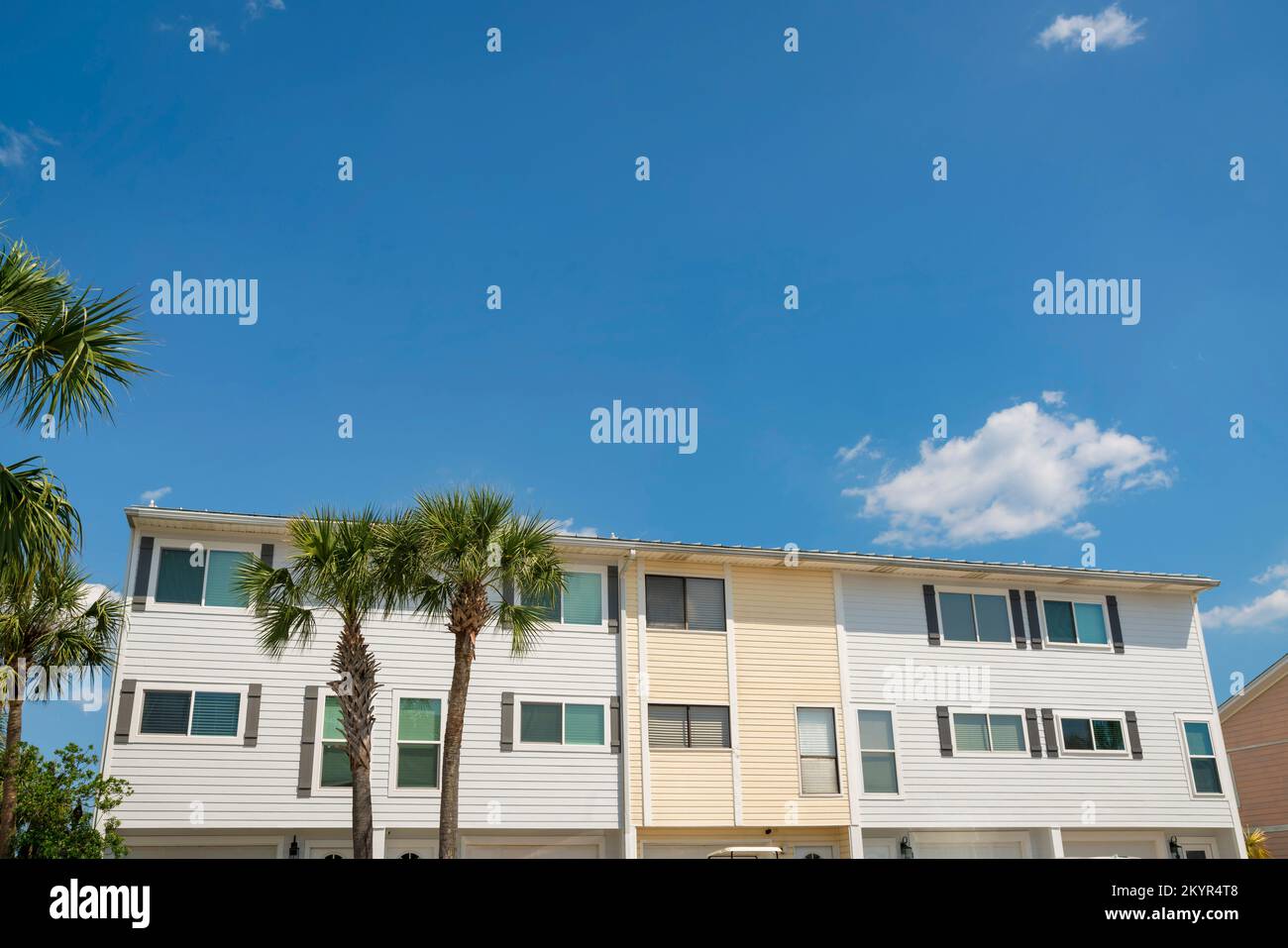 Townhomes with light yellow and white wood lap sidings at Destin