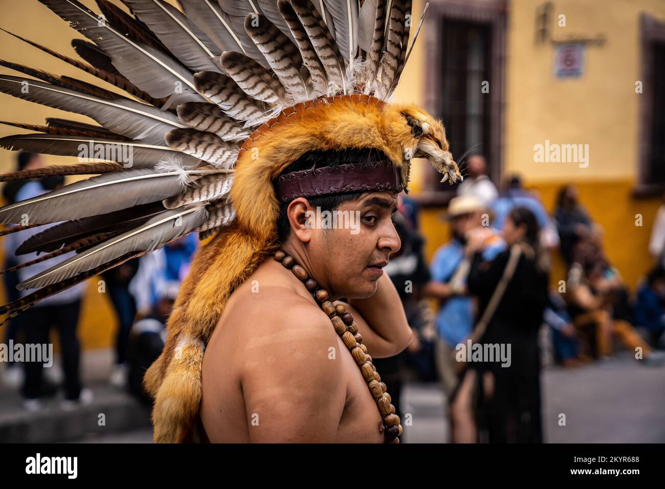 Indigenous man wearing a taxidermy animal head dress at the Danza de