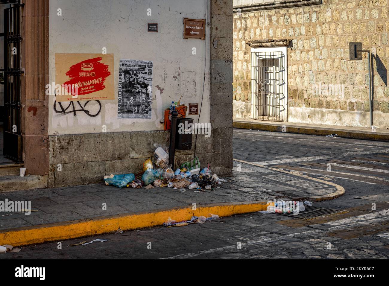Streets littered with garbage and overflowing trashcans the day after Christmas in Oaxaca City, Mexico Stock Photo
