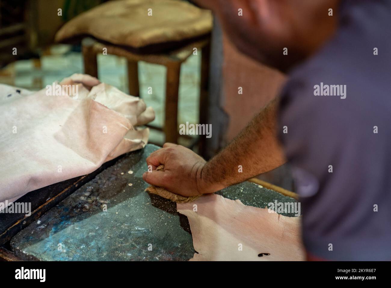 Smoothing leather at hide tannery in the Marrakech Medina, Morocco Stock Photo