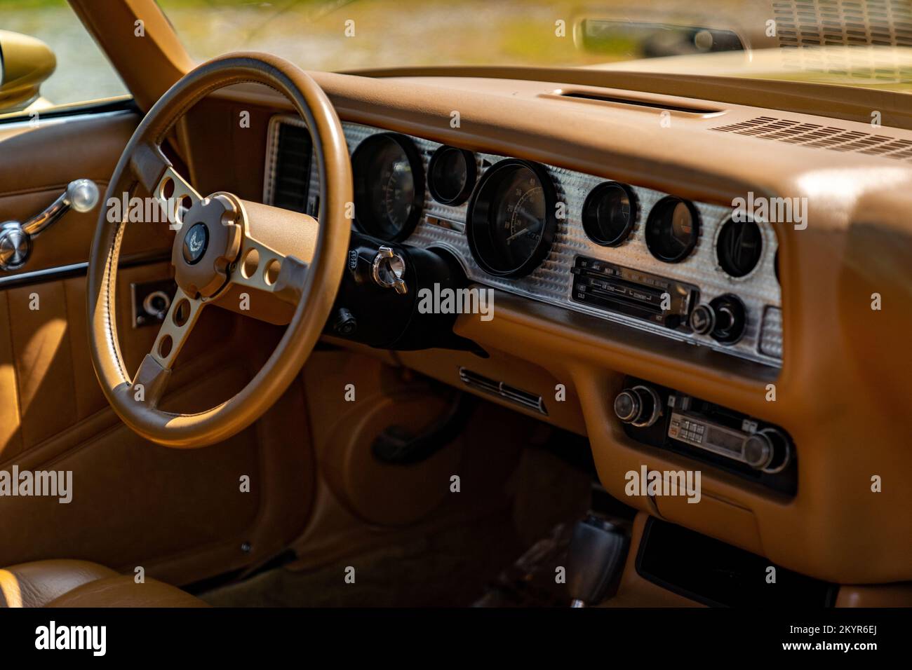 Dashboard and instrument panel of a Second-Generation Pontiac Firebird Trans Am in camel tan interior Stock Photo