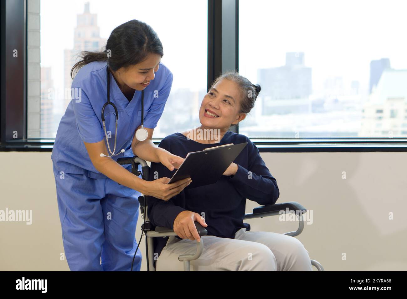 Woman physical therapist in blue uniform with stethoscope and clipboard