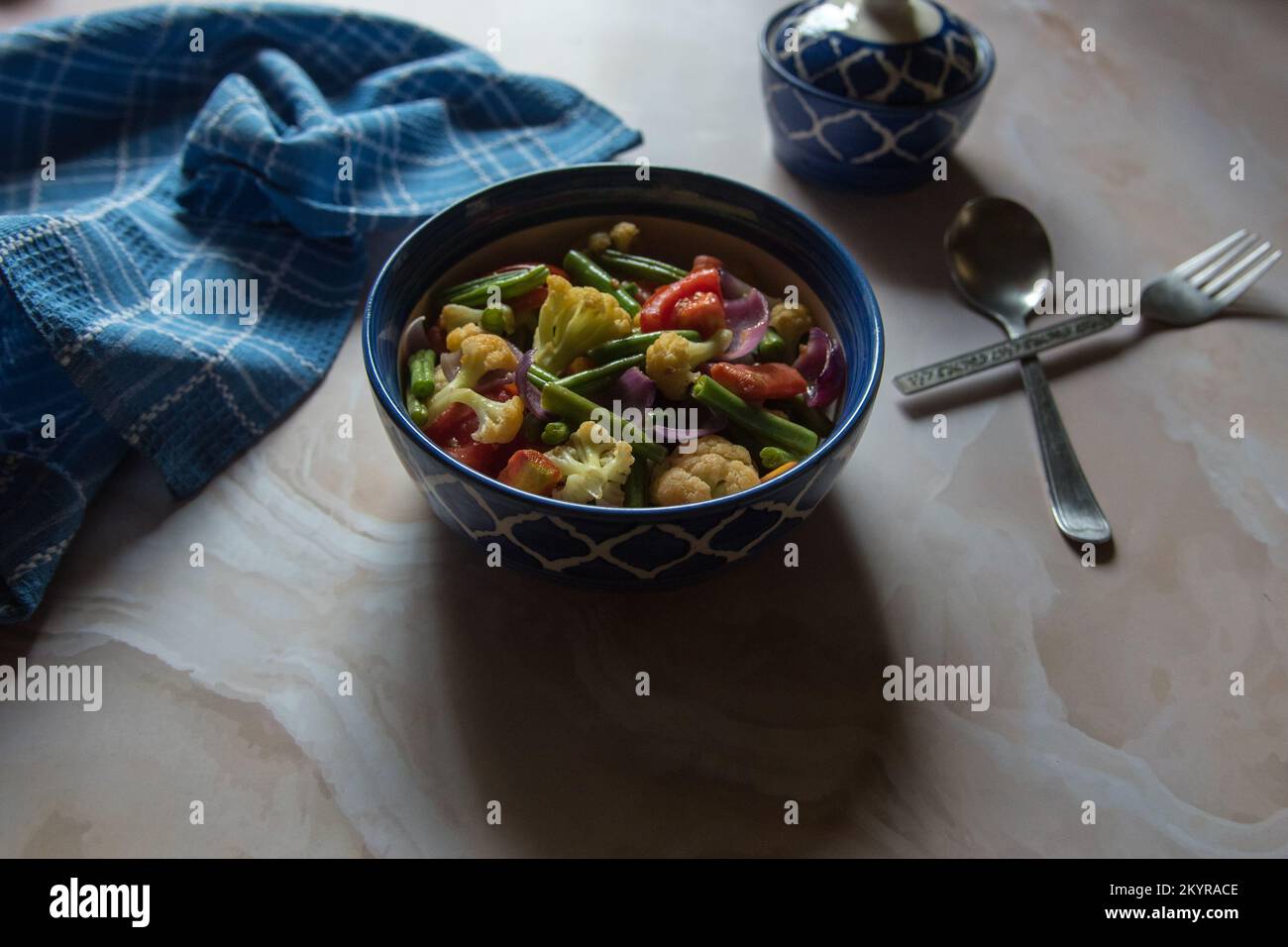 View from top of mixed vegetables curry served in a bowl. Stock Photo