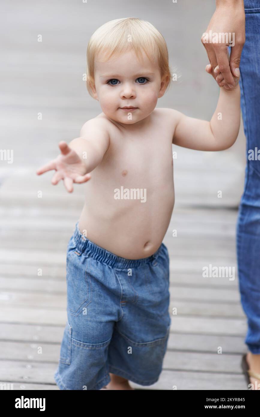Walking with mom. Portrait of a cute baby boy walking with his mother Stock Photo Alamy