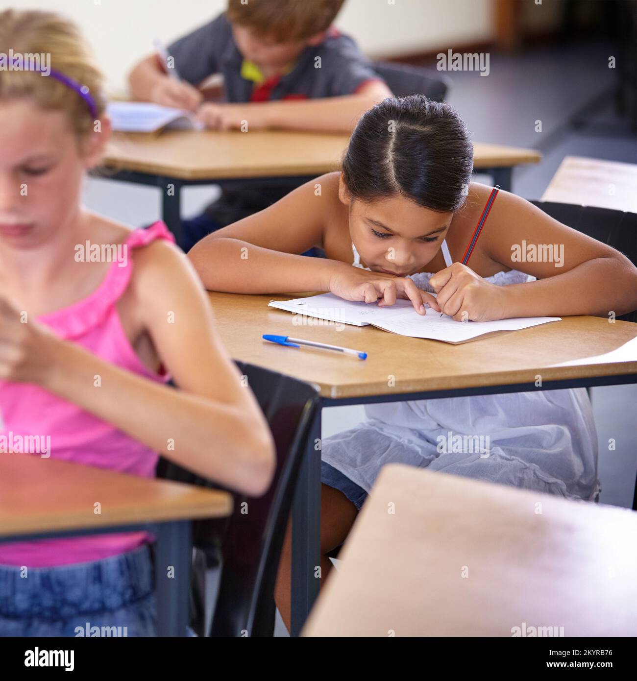 Nobody likes a pop quiz. students at their desks. Stock Photo