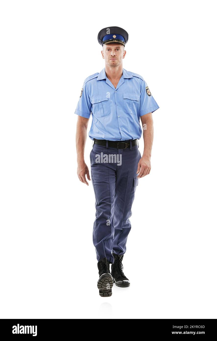 Walking the beat. Studio shot of a mature policeman isolated on white. Stock Photo