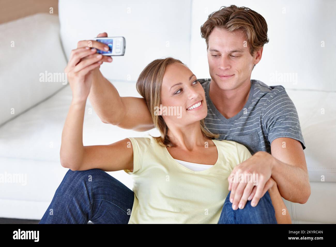 Making memories together. A young couple taking pictures with their ...