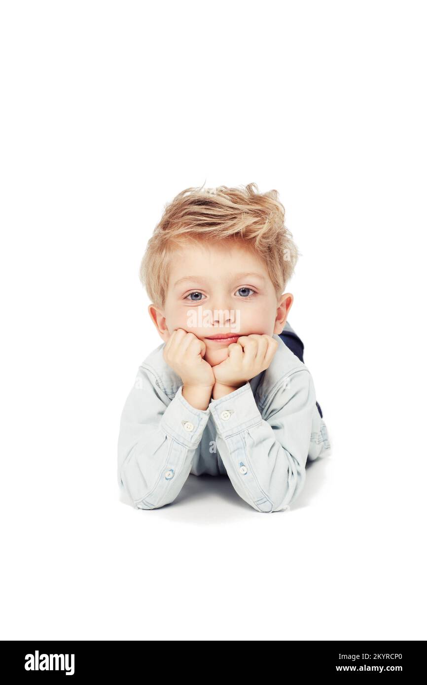 Dreaming of the big wide world...A cute little boy lying down looking