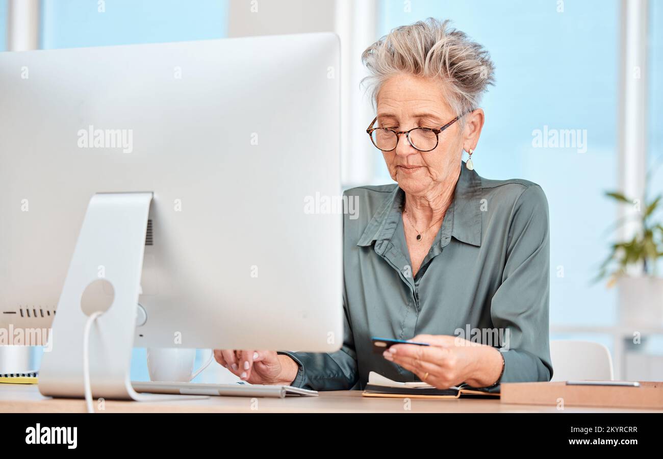 Business woman, credit card and computer with banking, online shopping and payment for bills on internet in a office. Senior woman, ecommerce and Stock Photo