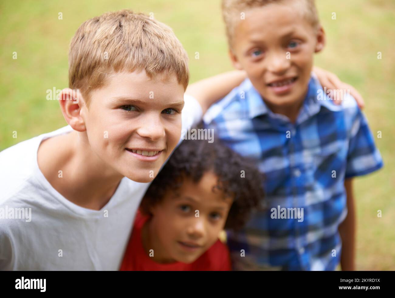 Enjoying Summer with my friends. Portrait of three young kids standing outside. Stock Photo