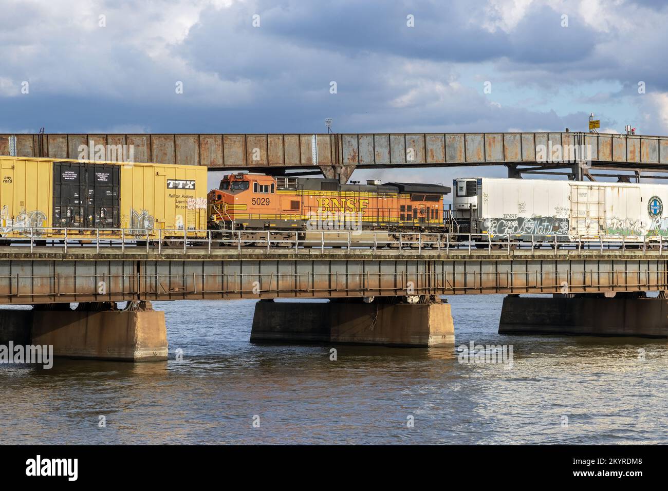 A westbound BNSF freight train crossing the Mississippi River on the Santa Fe Swing Span Bridge