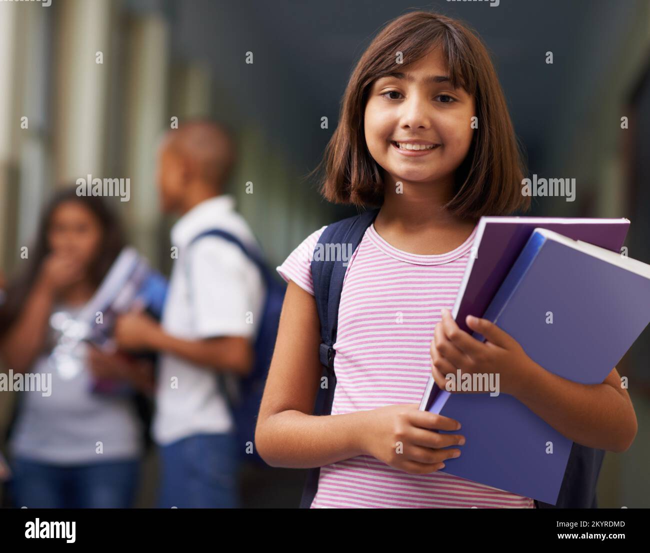 Shes a diligent student. Portrait of a happy school girl standing in