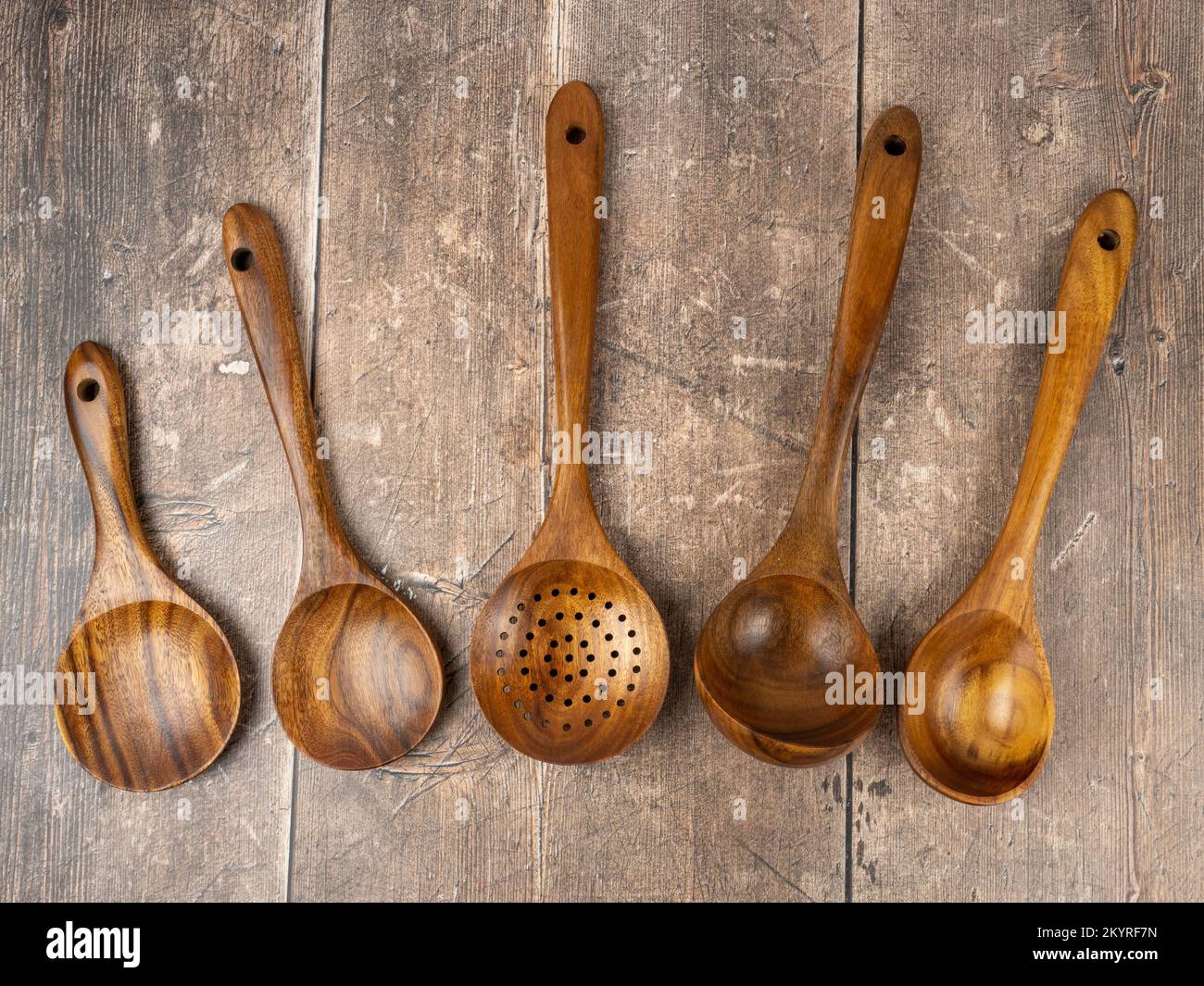 set of kitchen hardwood teak cooking utensils on a traditional rustic