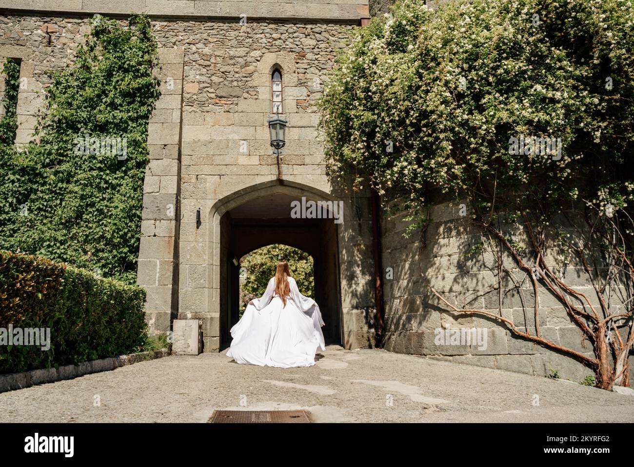 a beautiful woman in a white dress walks through a beautiful palace on ...
