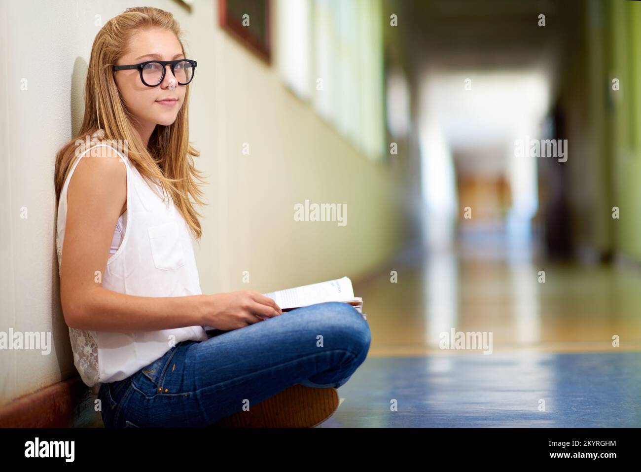 Shes a diligent student. a young girl in her school hallway. Stock Photo