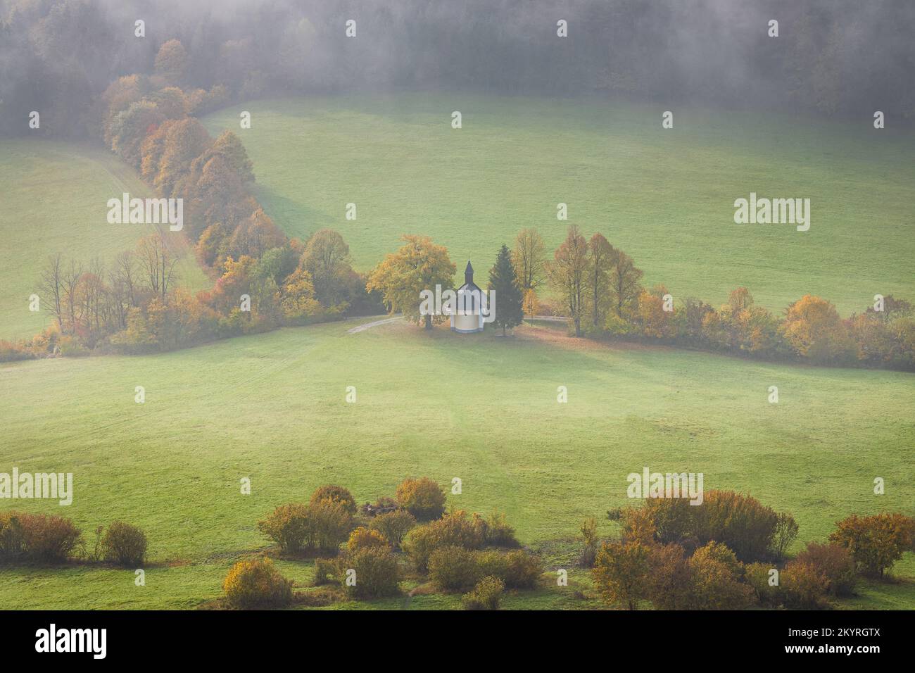 Autumn foggy country with a chapel under the Podskalsky Rohac hill in Strazov Mountains Protected Landscape Area, Slovakia, Europe. Stock Photo