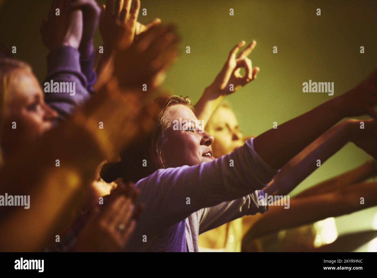 Enjoying every song the band plays. a crowd at a concert. Stock Photo