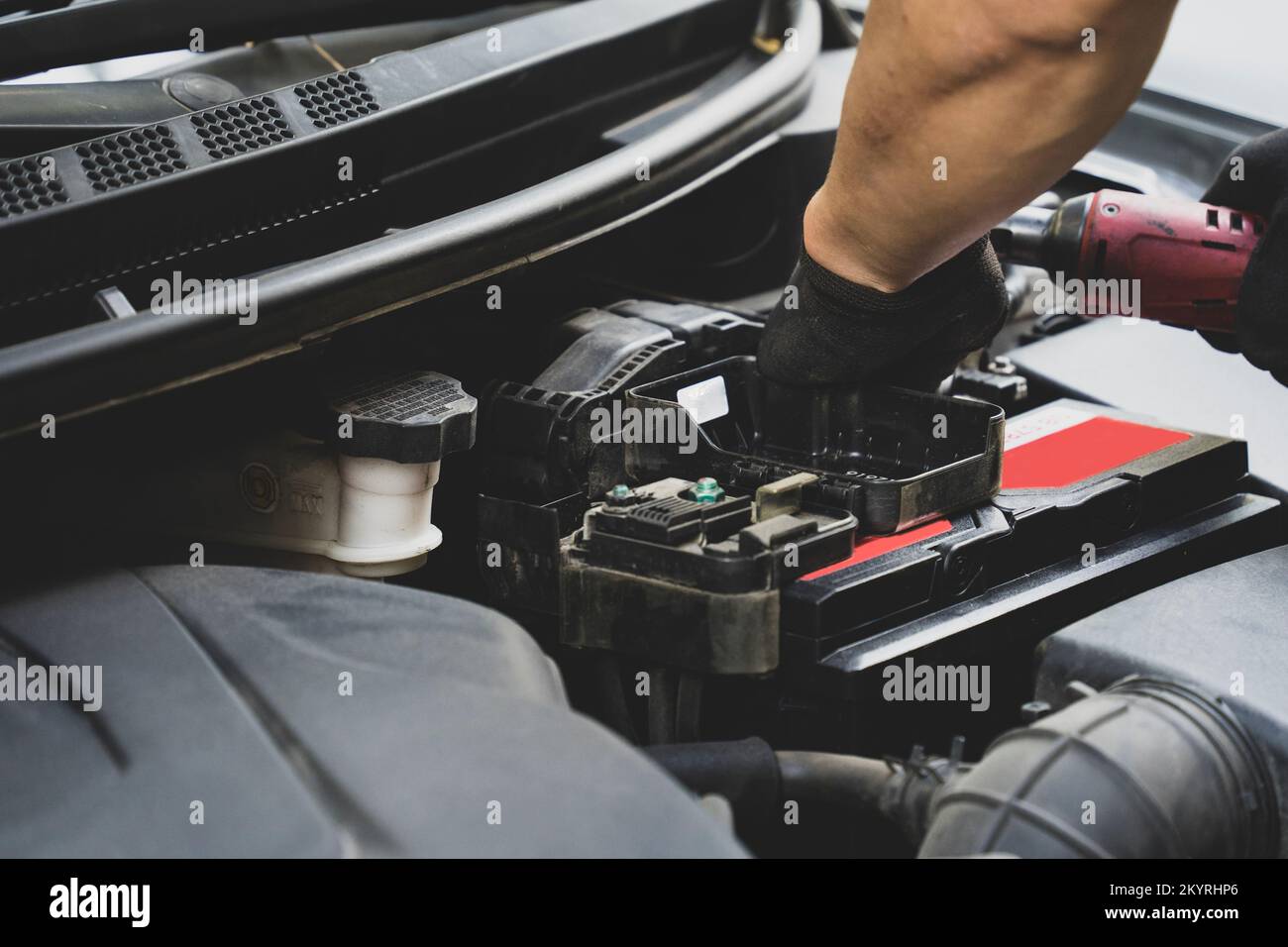 Picture of car parts and bumper repairman in front of car Stock Photo