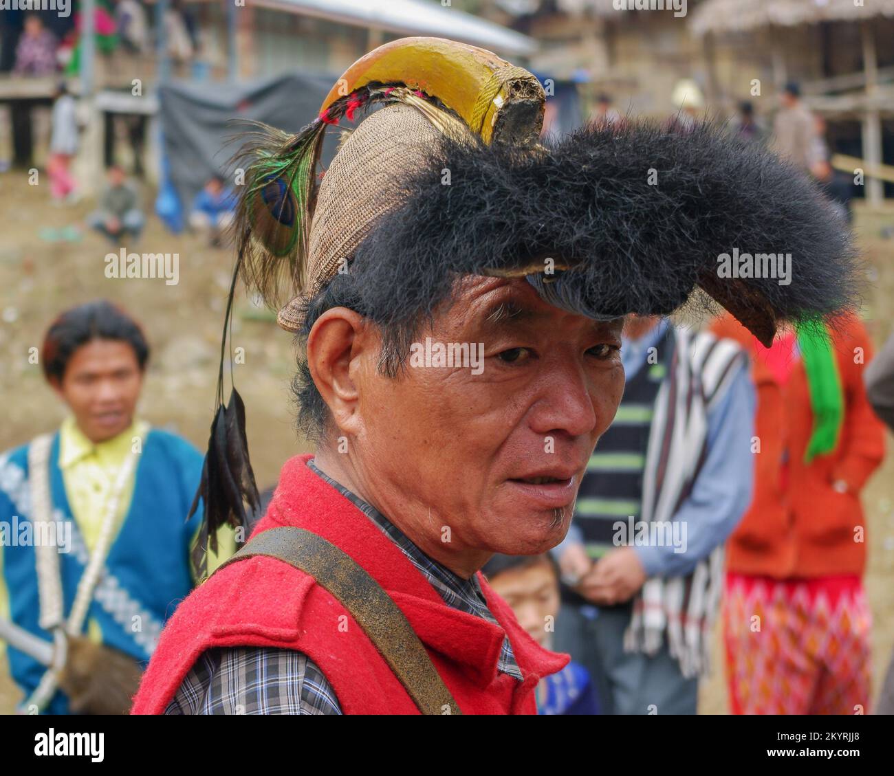 Raga, Arunachal Pradesh, India - 02 25 2009 : Portrait of Nyishi tribe man wearing traditional cane headgear with hornbill beak, feathers and bear fur Stock Photo