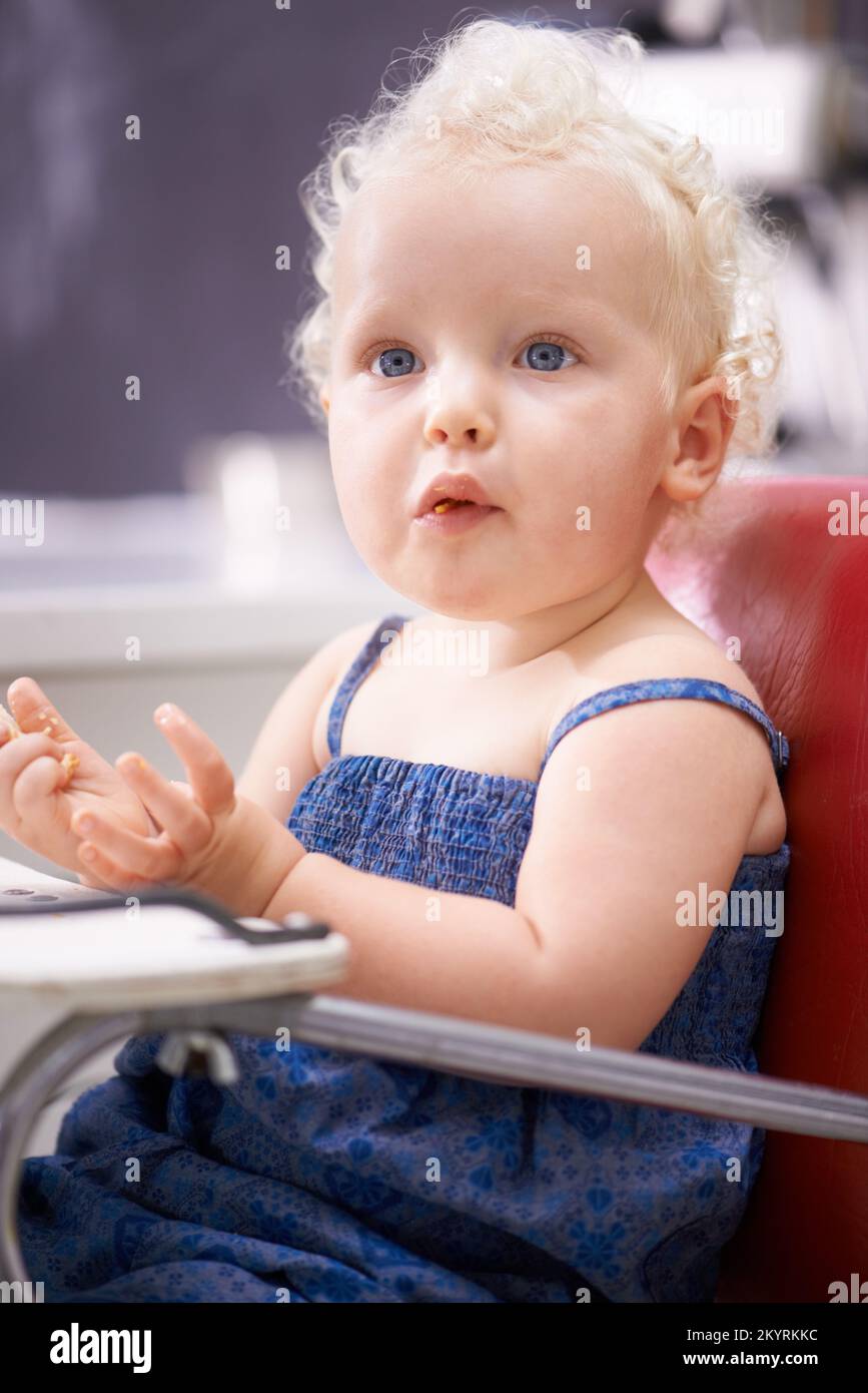 I can feed myself. A happy little baby eating solid food while sitting