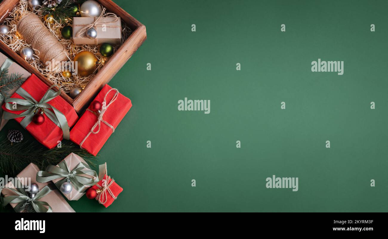 New Year banner with Christmas gift boxes and decorations on khaki background. Stock Photo