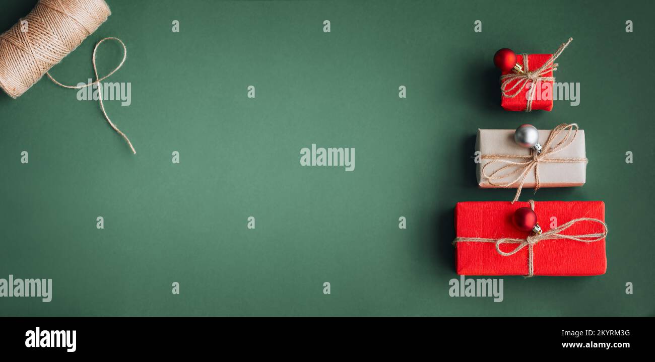 New Year banner with Christmas gift boxes and decorations on khaki background. Stock Photo