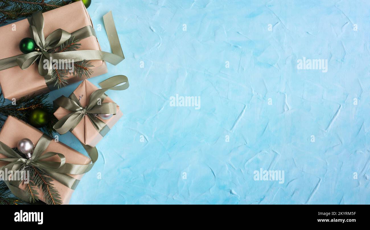 Christmas banner with many gift boxes with paper decorations on blue