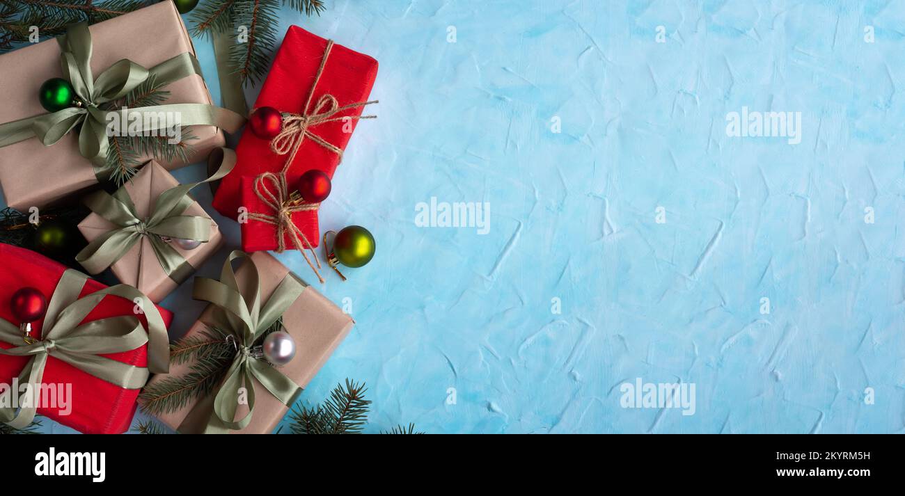 Christmas banner with many gift boxes with paper decorations on blue