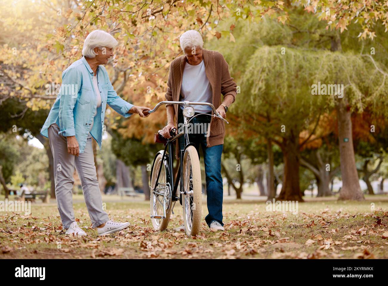 Senior couple, walking and bike in nature park together for romace date, quality time and relax freedom outdoor. Love, support care and summer walk Stock Photo