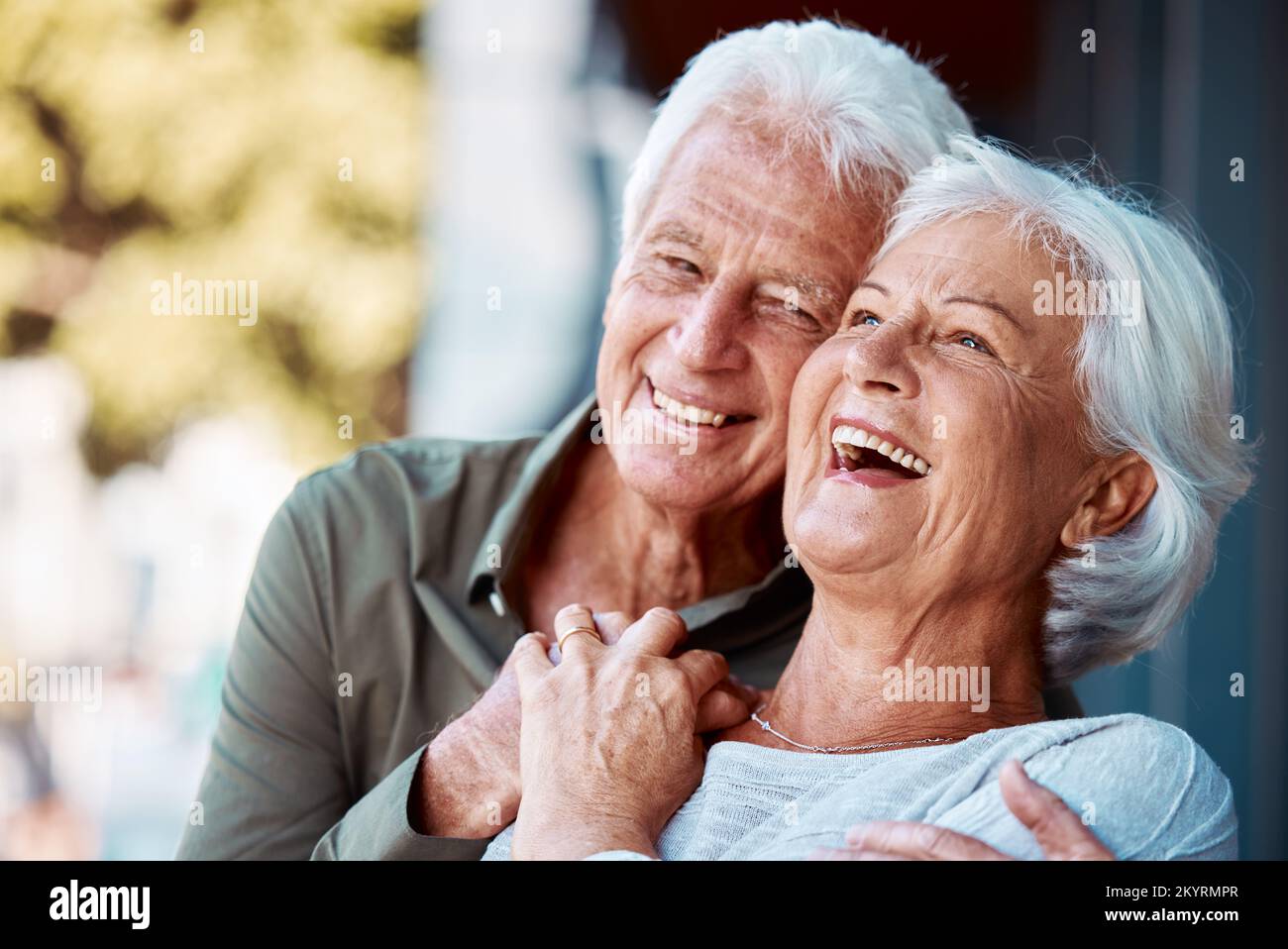 Senior couple, hug and laugh in park, happy and retirement to relax, wellness and fresh air in nature in Germany together. Happy elderly man, funny Stock Photo