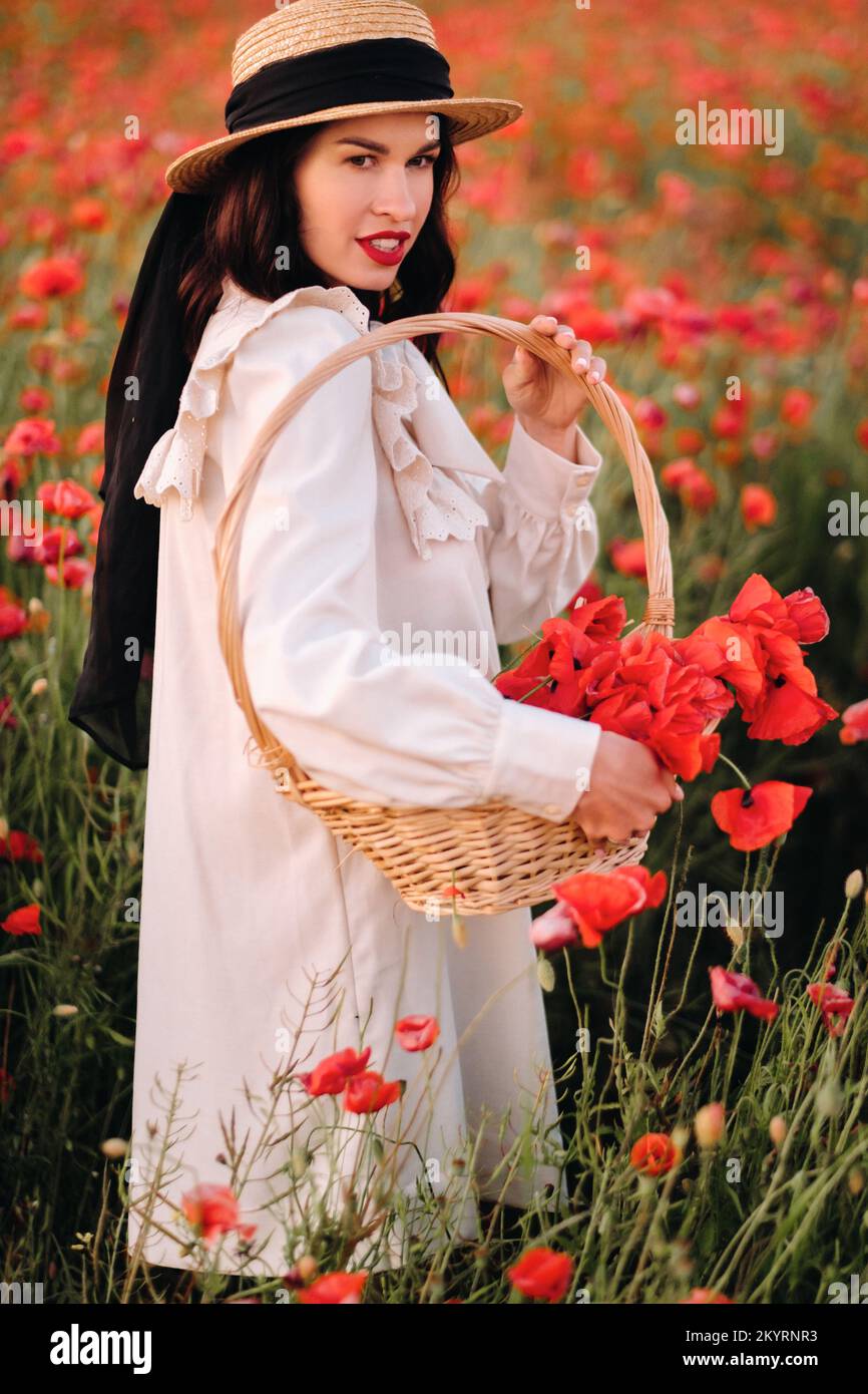 Portrait of girl in a poppy field hi res stock photography and