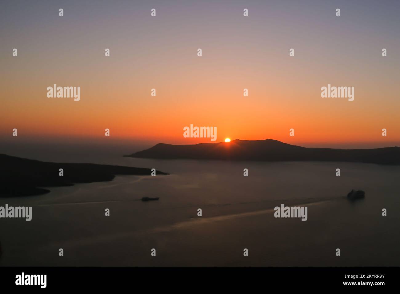 Spectacular sunset view and a ferry boat leaving the port of Athinios ...