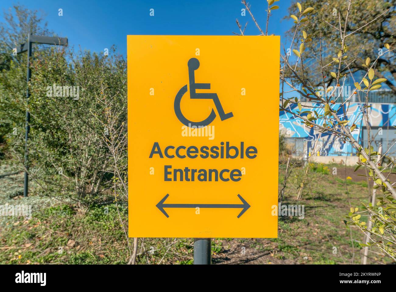 Wheelchair accessible entrance sign with arrow at Waterloo Park in