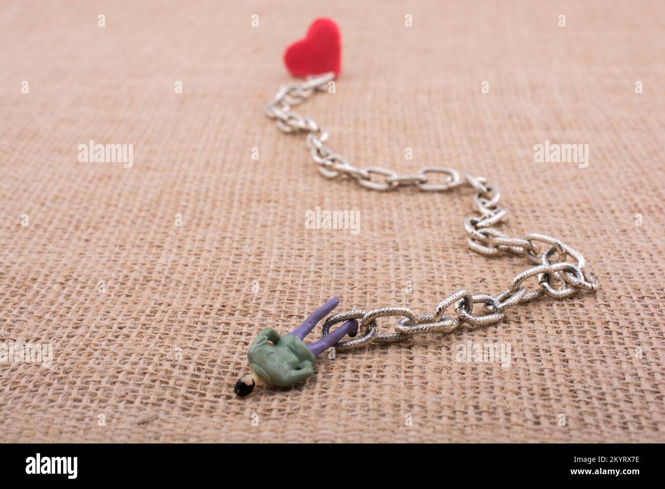 Heart shaped object attached to a man figurine on canvas Stock Photo ...