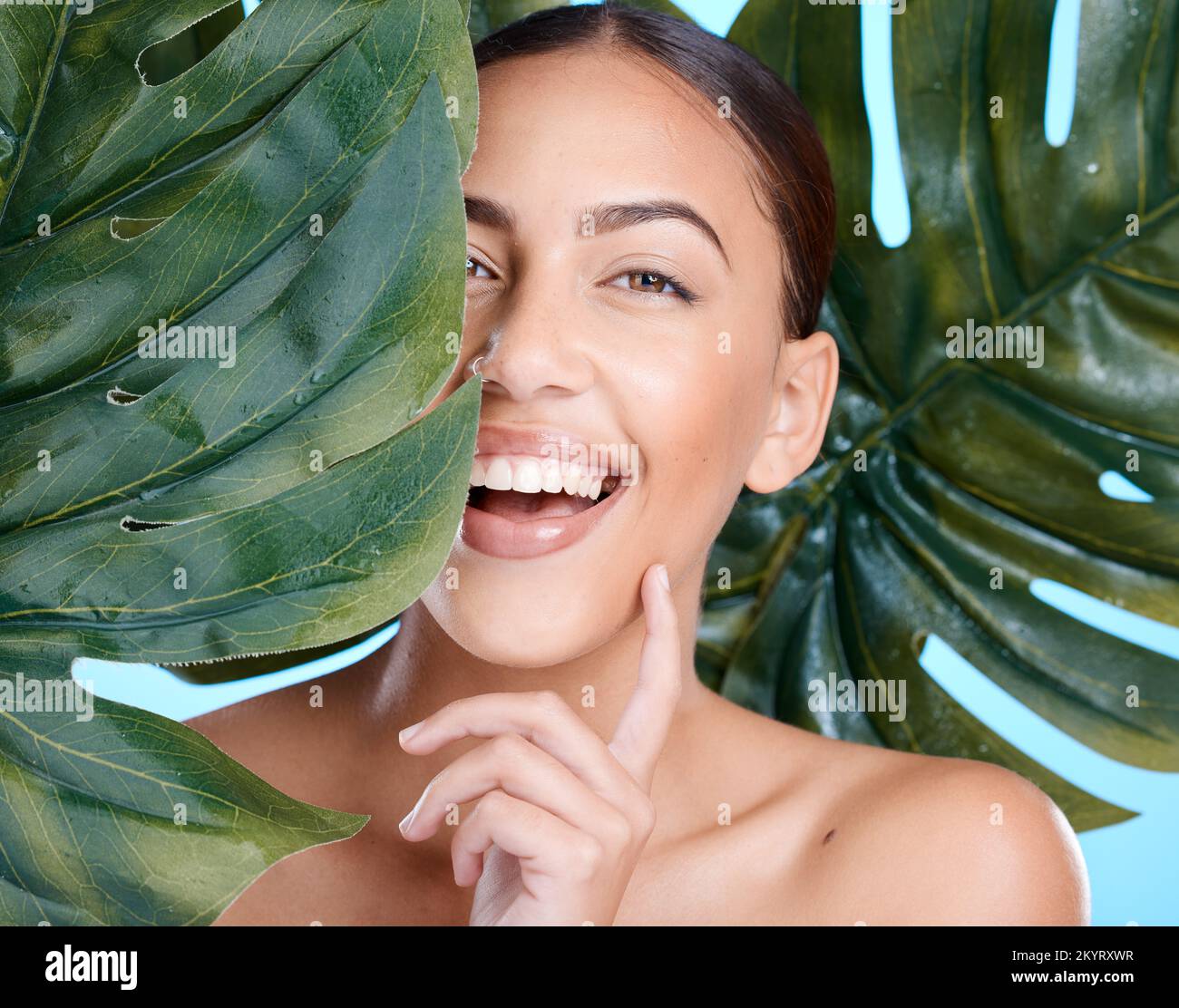 Skincare, plant leaf and happy woman in model portrait after wellness facial, skin self care or cosmetics. Person with health, beauty and natural Stock Photo