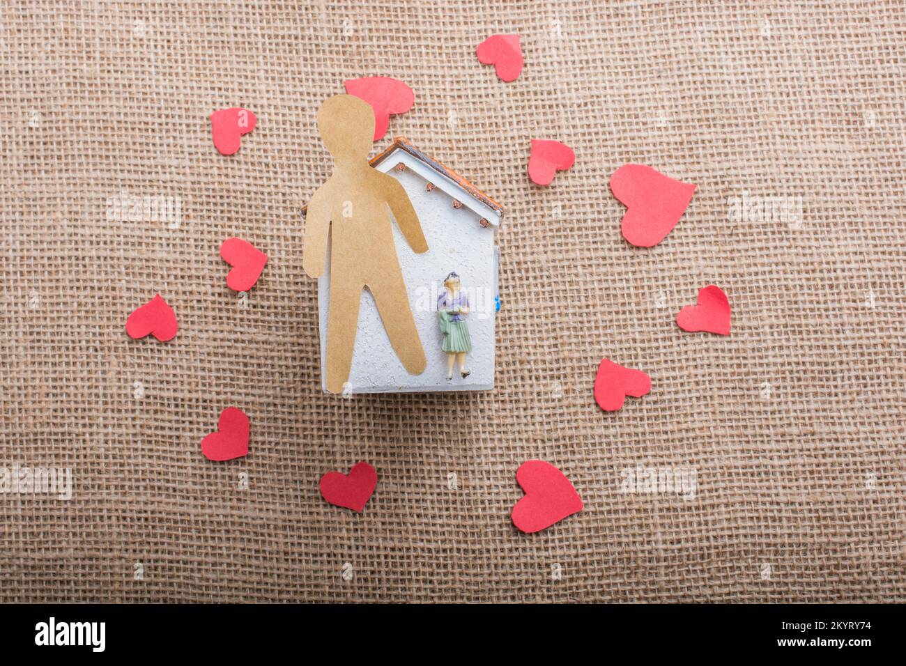 Heart shaped icons and paper house on canvas Stock Photo - Alamy