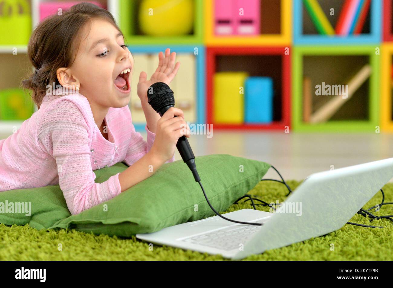 Adorable little girl singing karaoke Stock Photo Alamy
