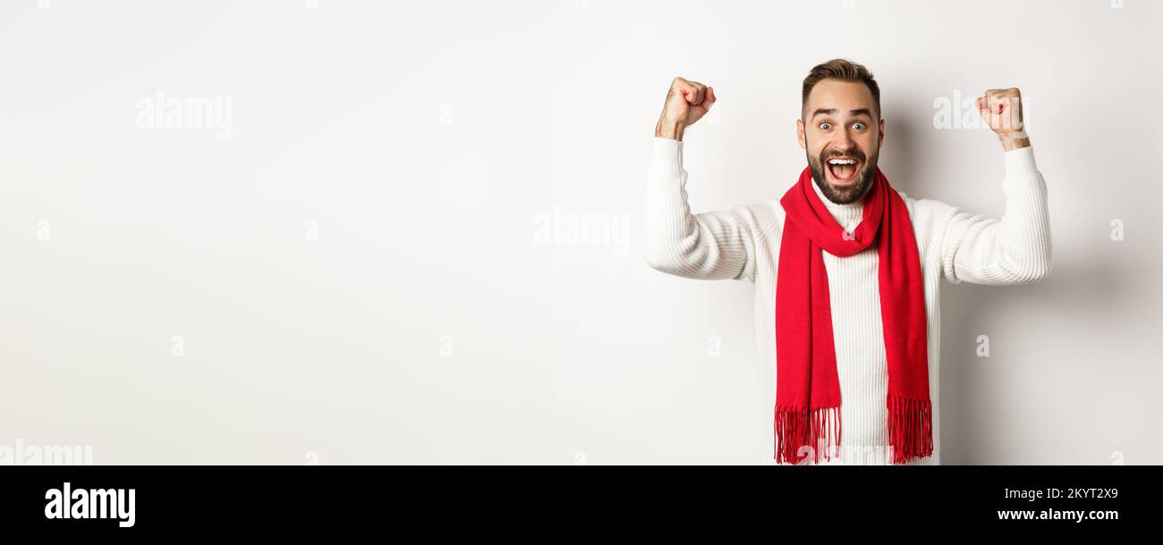 Christmas holidays and New Year concept. Excited man rejoicing, winning ...