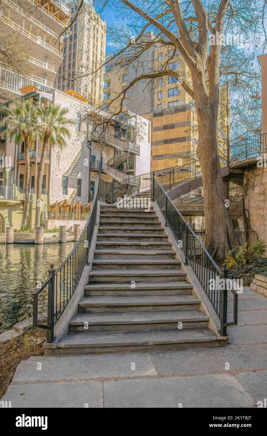 Stairs going up a building overlooking the canal in San Antonio River ...